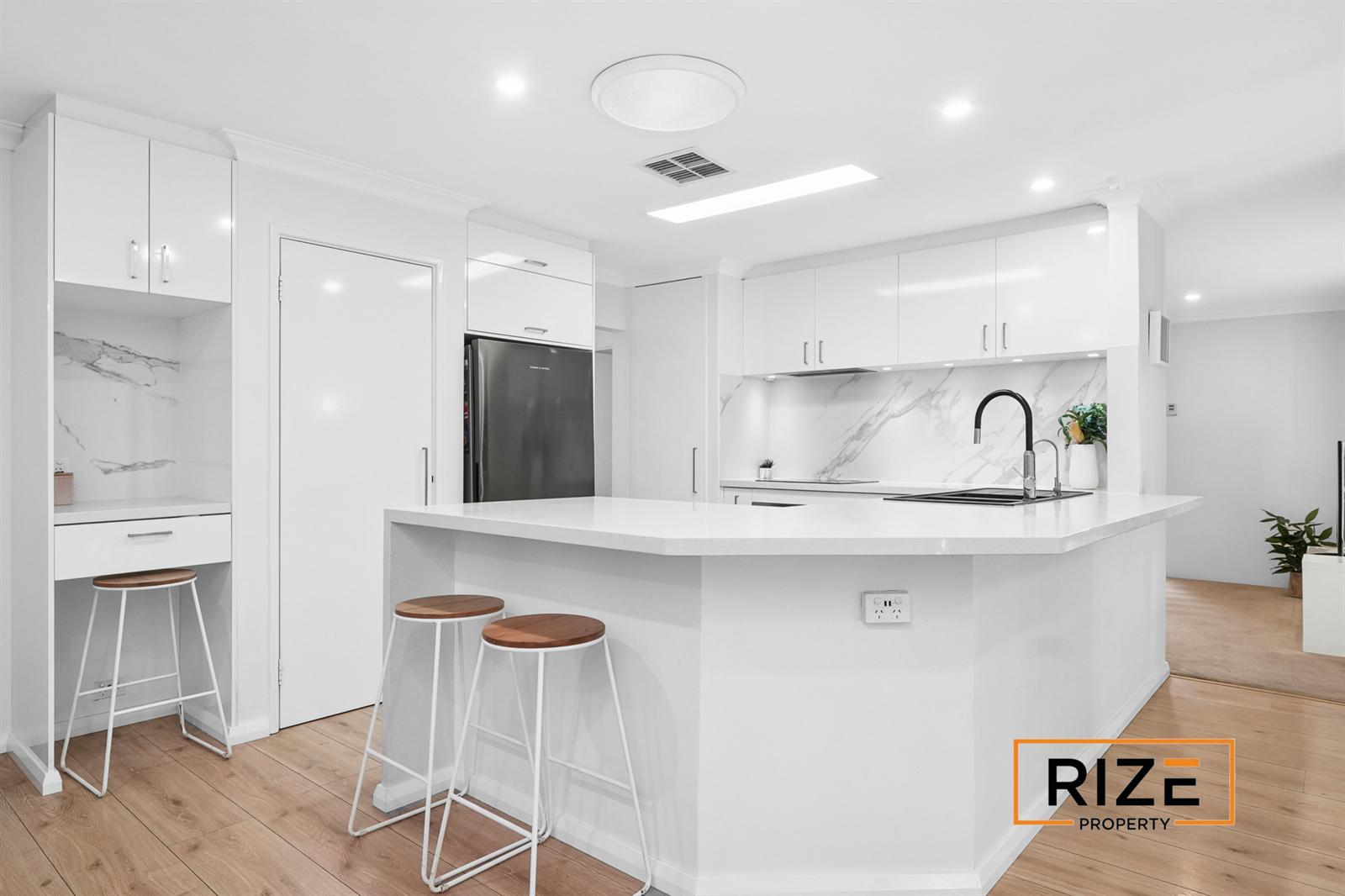 Stone benchtops, breakfast bar and stone splashbacks