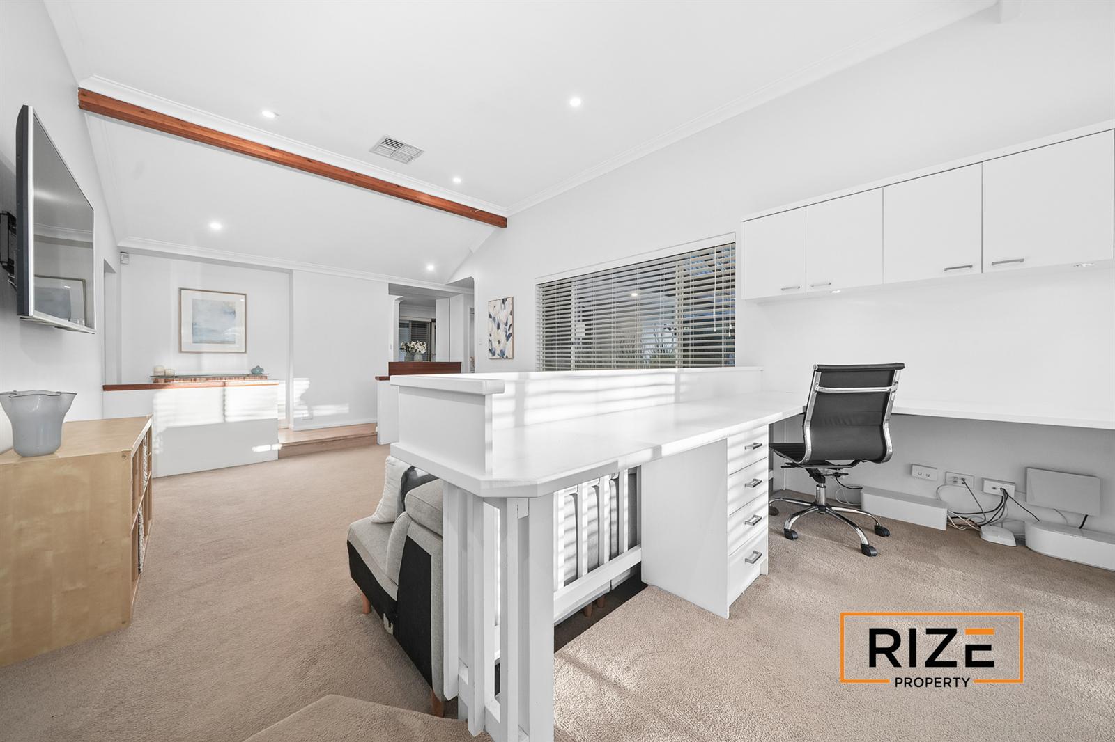 Built-in desk and overhead joinery in the home office