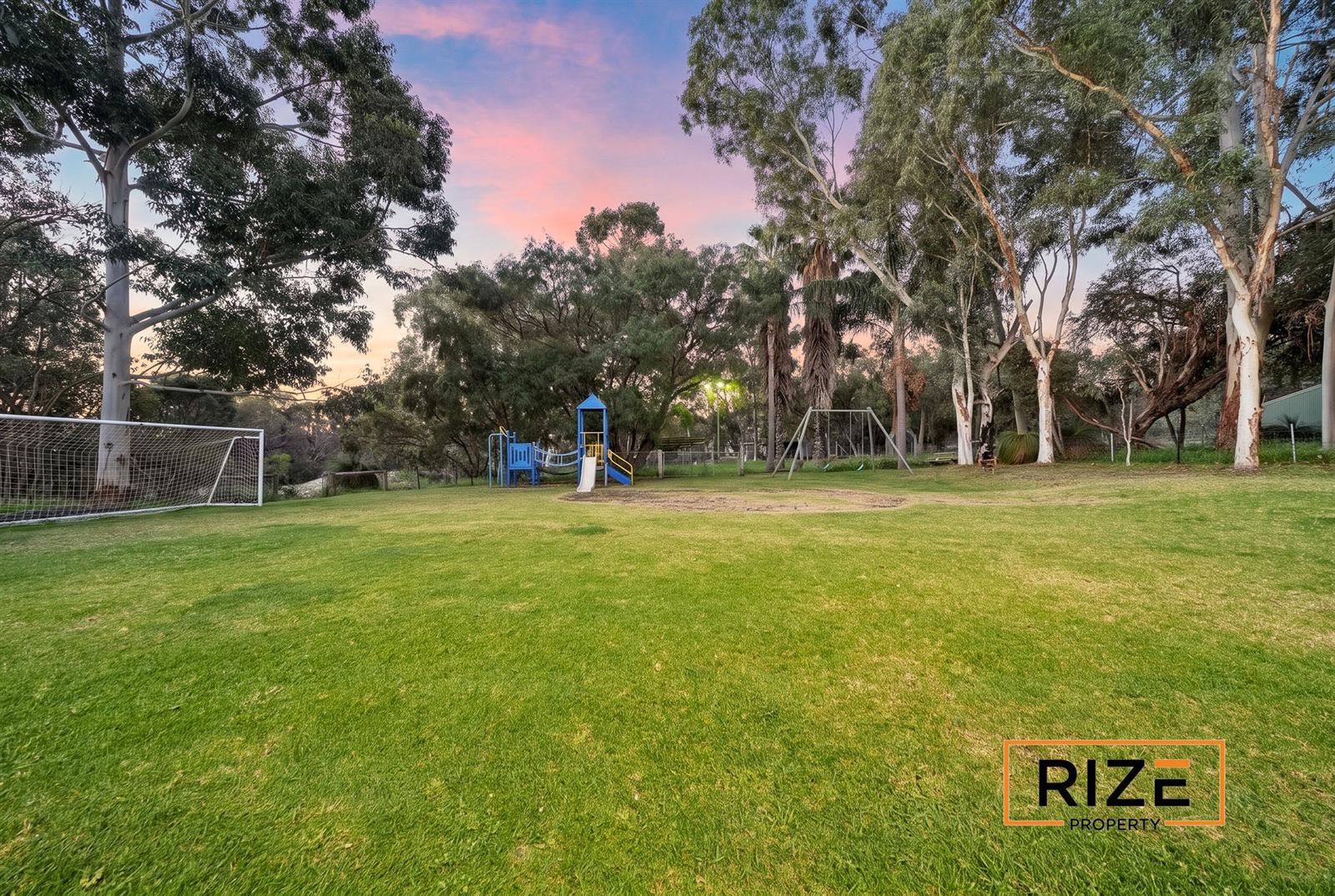 Level lawn with goals and playground