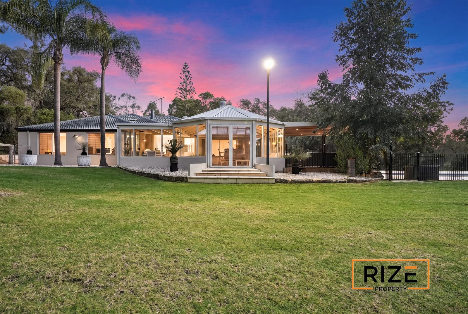 The home at dusk across the lawn
